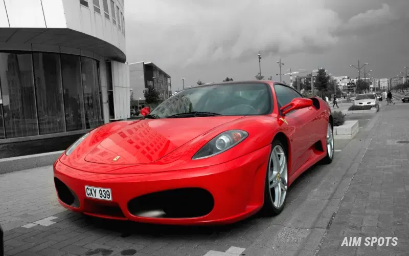 red ferrari driving through barcelona streets
