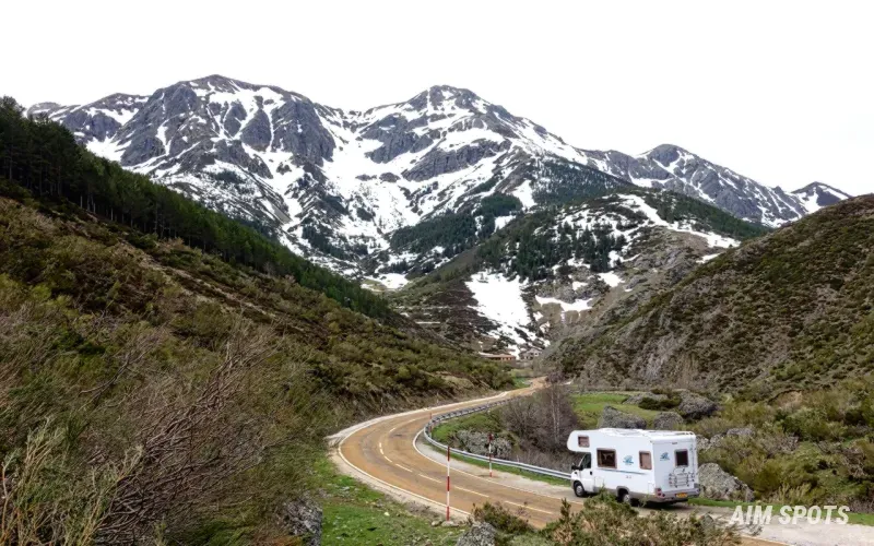 scenic camper van parked near a mountain sunset