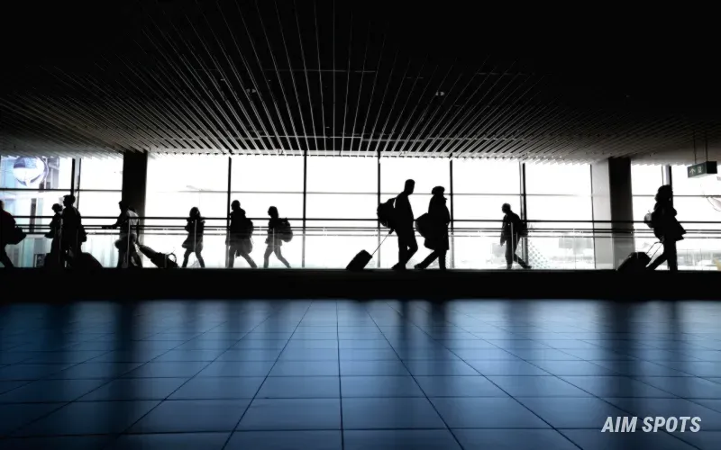 crowded airport departure board with cancellations