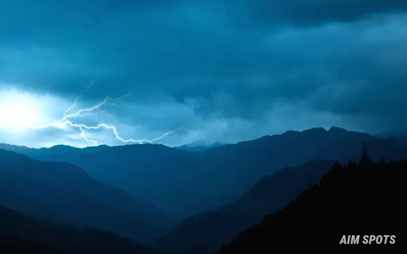 storm clouds rolling over a green field
