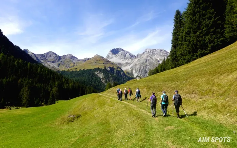 group of hikers smiling on trail