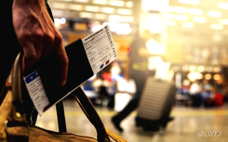 luggage and boarding pass at airport terminal